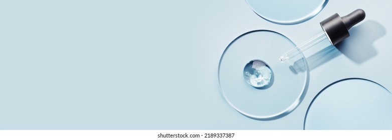 Pipette with sample of gels cosmetic product in petri dish on blue banner, hard shadows - Shutterstock ID 2189337387