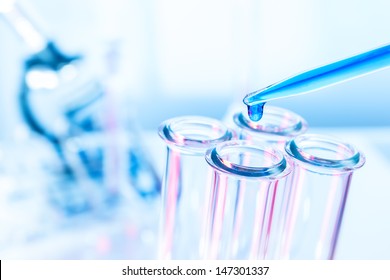Pipette and test tube on blue background - Powered by Shutterstock - Get 15% off with code: PIKWIZARD15