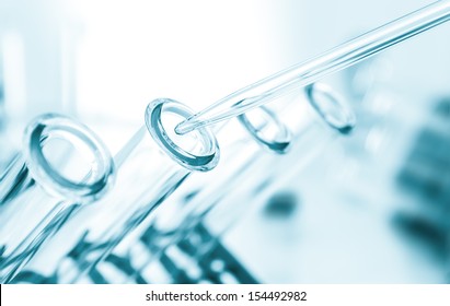 pipette and test tube on blue background 