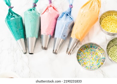 Piping Bag With Metal Tips Filled With Colorful Italian Buttercream Frosting.