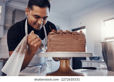 Piping, bakery and chef baking a cake with chocolate and pastry in a kitchen and is happy decorating his recipe. Food, dessert and cook preparing a sweet meal by a Brazil man and adds cream - Powered by Shutterstock