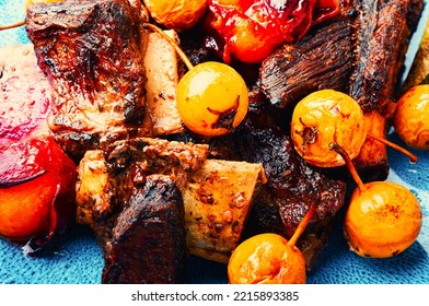 Piquant lamb ribs baked with pear and plum. - Shutterstock ID 2215893385