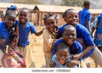 PIRA, BENIN - JAN 12, 2017: Unidentified Beninese Children In School Uniform Have Fun. Benin Kids Suffer Of Poverty Due To The Bad Economy.