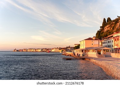 Piran Pirano sea port evening sunset, red and green lighthouse, pier, Slovenia Slovenija coast, Adriatic sea, Istria