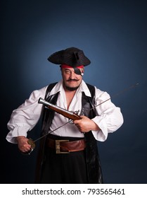 Pirate with a beard on a blue background in the studio