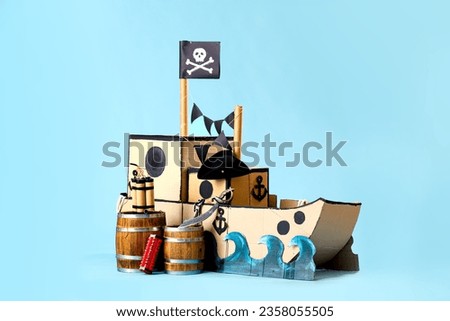 Pirate cardboard ship with explosive on blue background