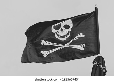 Pirate flag, black and white skull and bones, Jolly Roger. - Shutterstock ID 1925659454