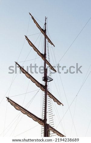 Pirate ship mast on blue sky background