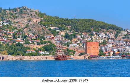 Pirate ship on the water of Mediteranean sea - Pirate ship sailing around the red tower ottoman fortress