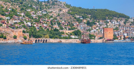 Pirate ship on the water of Mediteranean sea - Pirate ship sailing around the red tower ottoman fortress