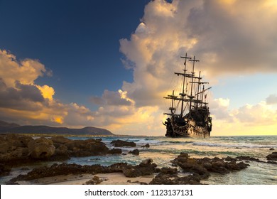 Pirate ship at the open sea at the sunset - Shutterstock ID 1123137131