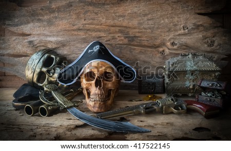 pirate skull or skeleton human on wood background , still life concept 