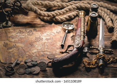 Pirate treasure map and human skull on brown wooden table closeup background.