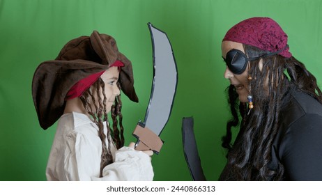 Pirates getting angry and fighting with cutlasses. Isolated on green background. High quality photo