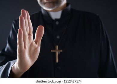 Pirest Hand Blessing Closeup With Cross And Clergyman Background