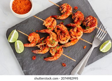 Piri Piri Grilled Shrimp On The Skewers With Lemon And Condiment On A Platter Top Down Flat Lay Photo