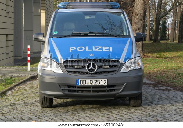 Pirna,\
Germany, 02-15-2020, a police car of the saxon police in a park\
beside the courthouse in\
Pirna-Sonnenstein