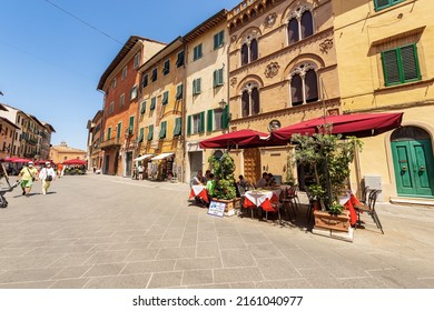 PISA, ITALY - JULY 29, 2020: Tourists and outdoors restaurants in Pisa downtown, street called Via Santa Maria. UNESCO world heritage site, Tuscany, Italy, Europe.