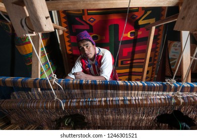 Pisac, Peru - August 12 2011: A Man Working And Making Tapestry At His Place.