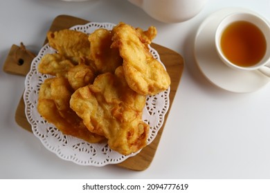 Pisang Goreng Or Banana Fritter Or Fried Banana Serve In Wooden Plate With White Background