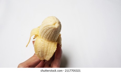 pisang susu is a local banana type from indonesia. a single ripe banana on isolated white background.pelled and bitten banana perfect for diet and vegan. health and diet reference