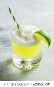 Pisco Sour Cocktail In Rocks Glass With A Lime And Straw