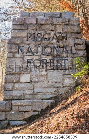 Pisgah National Forest stone entrance sign on a fall day, North Carolina