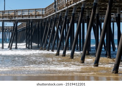 Pismo Beach, Pismo Pier, CA, USA: Wooden pier, ocean waves, recreation, surfing, vendors and sport fishing destination. Pacific Ocean Chumash Heritage National Marine Sanctuary. 
 - Powered by Shutterstock