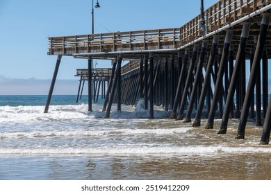 Pismo Beach, Pismo Pier, CA, USA: Wooden pier, ocean waves, recreation, surfing, vendors and sport fishing destination. Pacific Ocean Chumash Heritage National Marine Sanctuary. 
 - Powered by Shutterstock