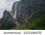 Pissing Mare Falls plunging into Western Brook Pond with steep rock cliff at Gros Morne National Park Newfoundland