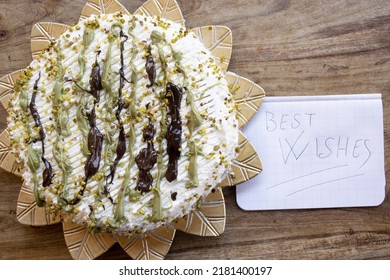 Pistachio And Chocolate Cake With The Inscription Best Wishes