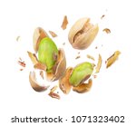 Pistachio crushed in the air close-up isolated on white background