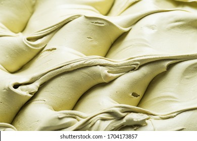 Pistachio flavour gelato - full frame detail. Close up of a creamy green surface texture of Pistachio Ice cream.
