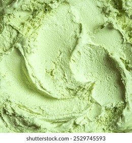 Pistachio ice cream texture, square background. Homemade green vegan ice cream or gelato closeup.