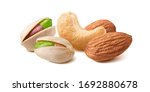 Pistachios, almonds and cashew nuts mix isolated on white background. Package design element with clipping path