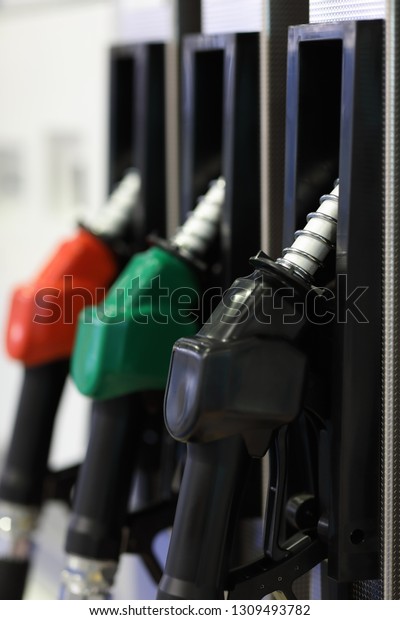 Pistol\
fuel dispenser at a gas station. Selective\
focus.