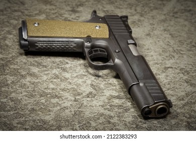 Pistol M1911 45 Acp. Caliber closeup photo.