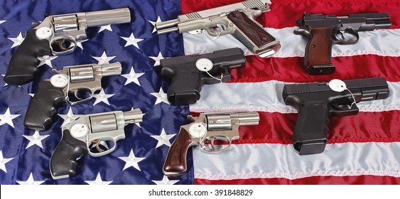 Pistols And Revolver Assorted Firearms For Sale On USA America Flag At Gun Show