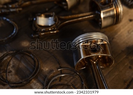 piston and connecting rod on the table, disassembled engine, repairing an engine