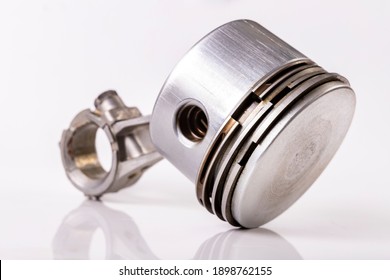 Piston And Connecting Rod Of A Small Internal Combustion Engine. Spare Parts For Engine Repair And Regeneration. Light Background.