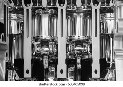 Pistons Of A Car Engine. Close Up Of An Industrial Product. A Black And White Image Of Machine Parts.