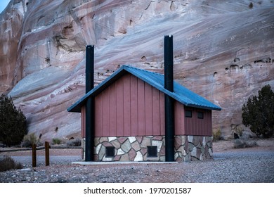 Pit Toilet At White House Campground In Southern Utah In Front Of Tall Rock Wall