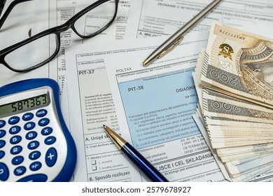 PIT-38 PIT 37 empty form, annual tax return to the tax office, zloty money calculator pen clock and glasses a