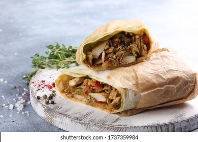 Pita Bread With Chiken, Vegetables And Spicy Sauce On White Wooden Board On Grey Table. Rolls In Parchment, Herbs, Spice. Shawarma, Wrap. Background Image, Copy Space 