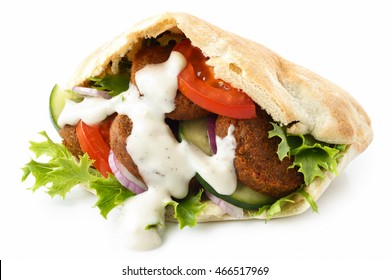 Pita bread filled with falafel, salad and white sauce isolated on white.