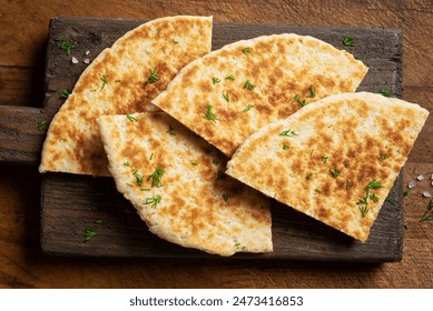 Pita bread on wooden background, top view. Georgian or arabian cuisine. Turkish food. Fresh homemade naan flatbread. Mediterranean traditional breakfast. - Powered by Shutterstock