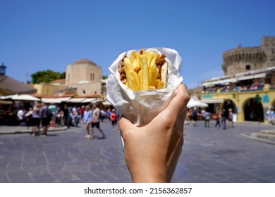 Pita Gyros. Greek gyros wrapped in pita breads against Greek old city square.