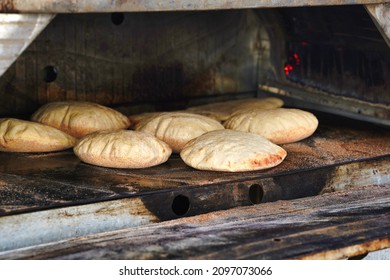 Pita Hot Bread From The Oven. Freshly Baked Gluten-free Flatbread Or Pitta. Fluffy, Round Bread To Be Stuffed With Food.