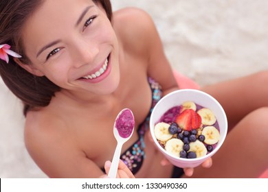 Pitaya Bowl Breakfast Smoothie - Asian Woman Eating Healthy Tropical Food On Beach. Girl Enjoy Acai Bowls Made From Acai Berries Or Dragonfruit Fruits. Girl On Hawaii Eating Local Hawaiian Dish.