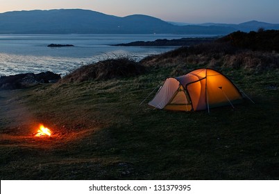 Pitched nylon tent erected for camping vacation near the beach and coast - Shutterstock ID 131379395